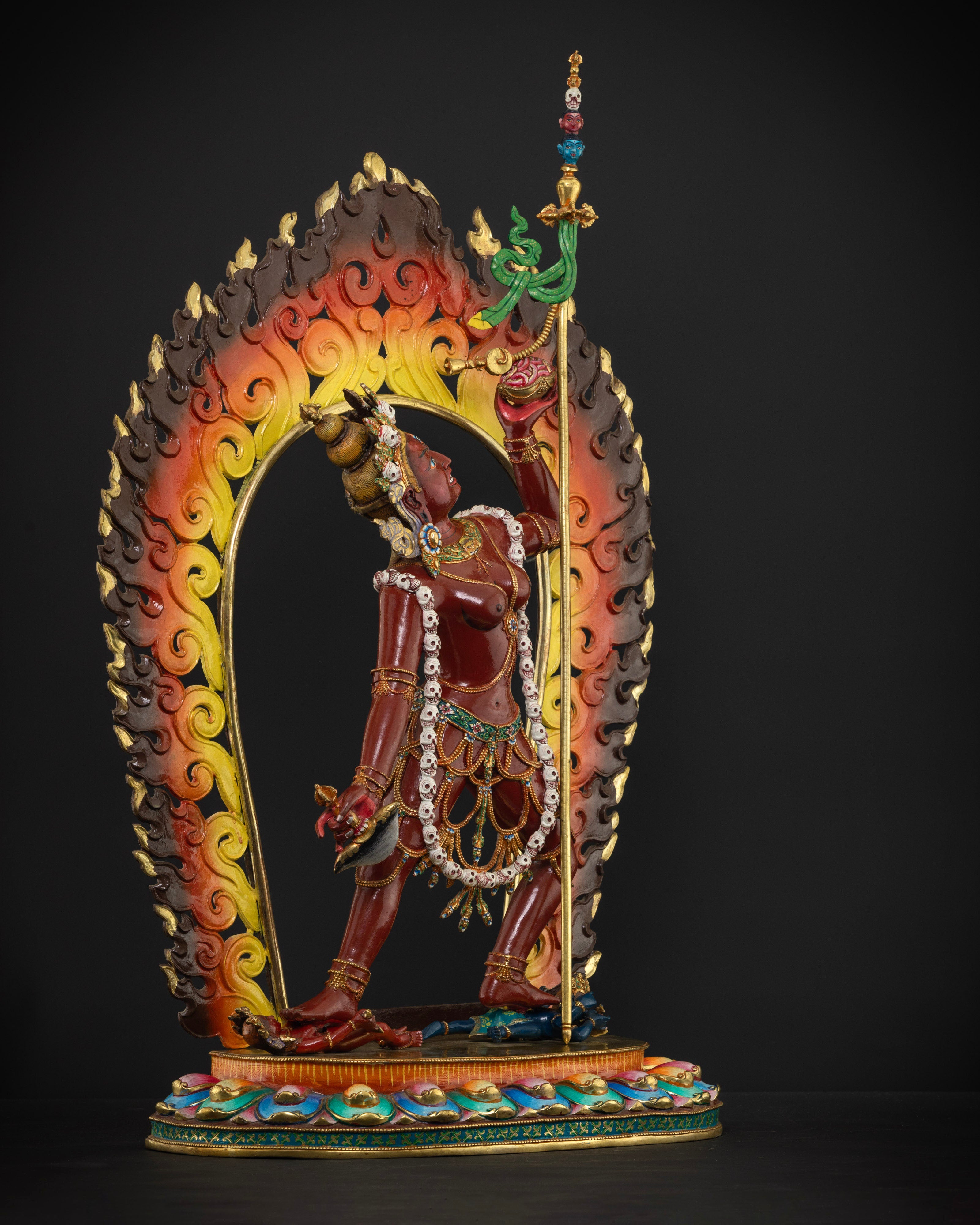 The Vajrayogini statue standing triumphantly on two figures, highlighting the dynamic fire halo and expert craftsmanship from Patan, Nepal.