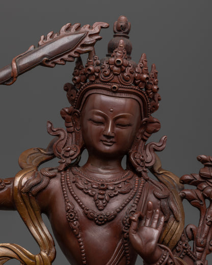 The Manjushri statue’s detailed craftsmanship, highlighting the flaming sword in the right hand and scripture in the left, set against a lotus base.

