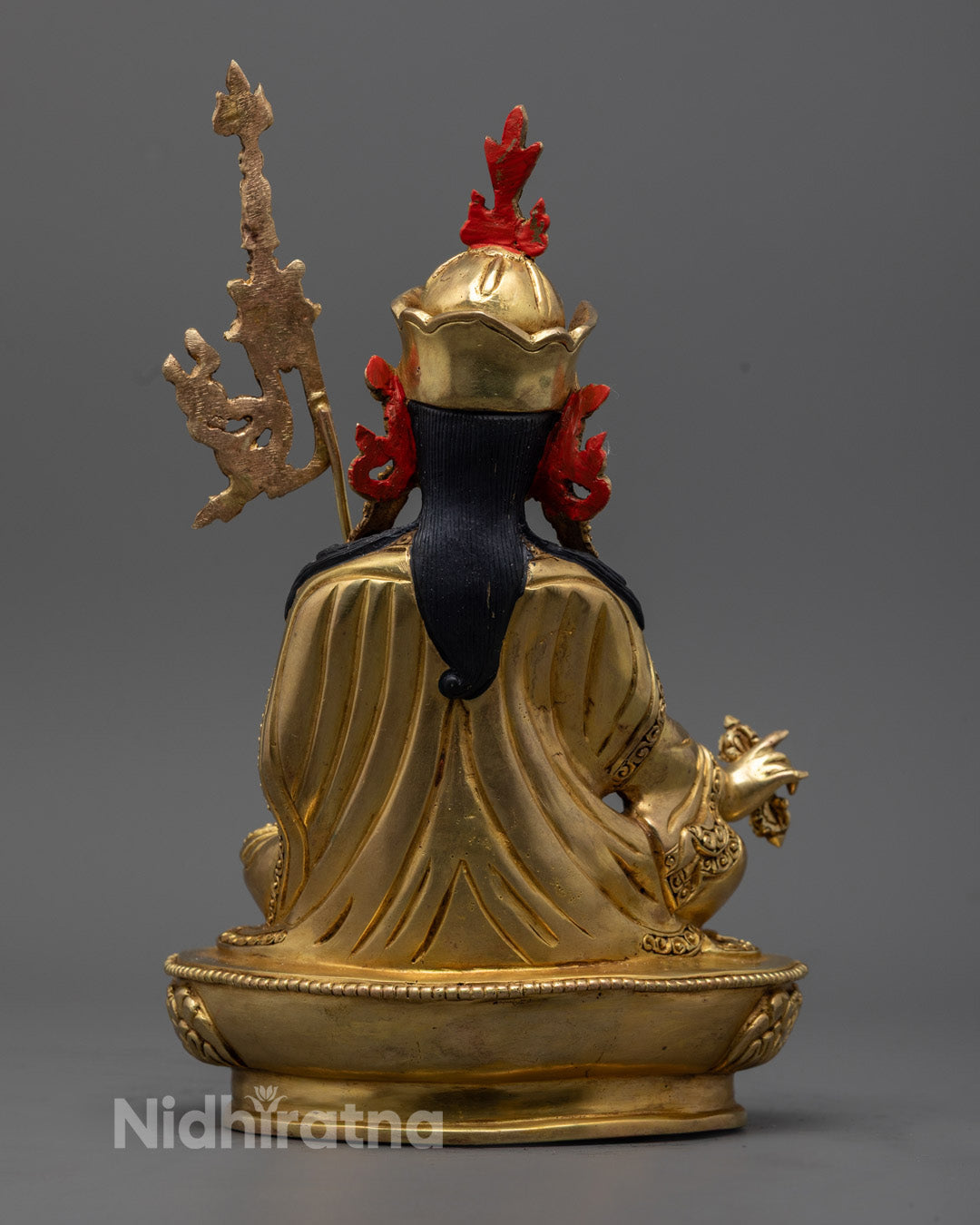 Three kapalas on the Guru Rinpoche statue symbolize transformation, wisdom, and liberation, representing protection and spiritual awakening.