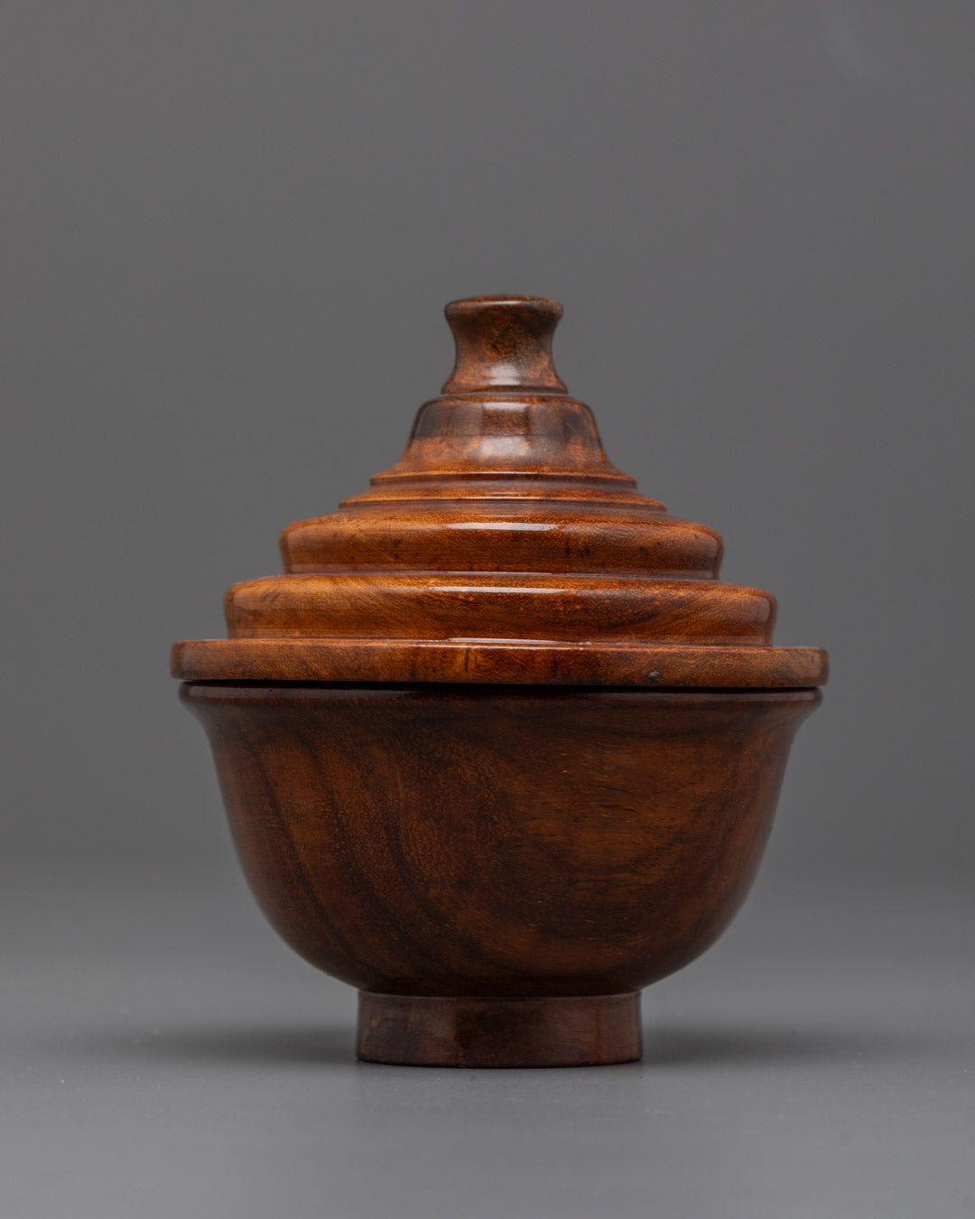 Close-up of detailed carving and smooth shiny surface on Tibetan wooden tea bowl