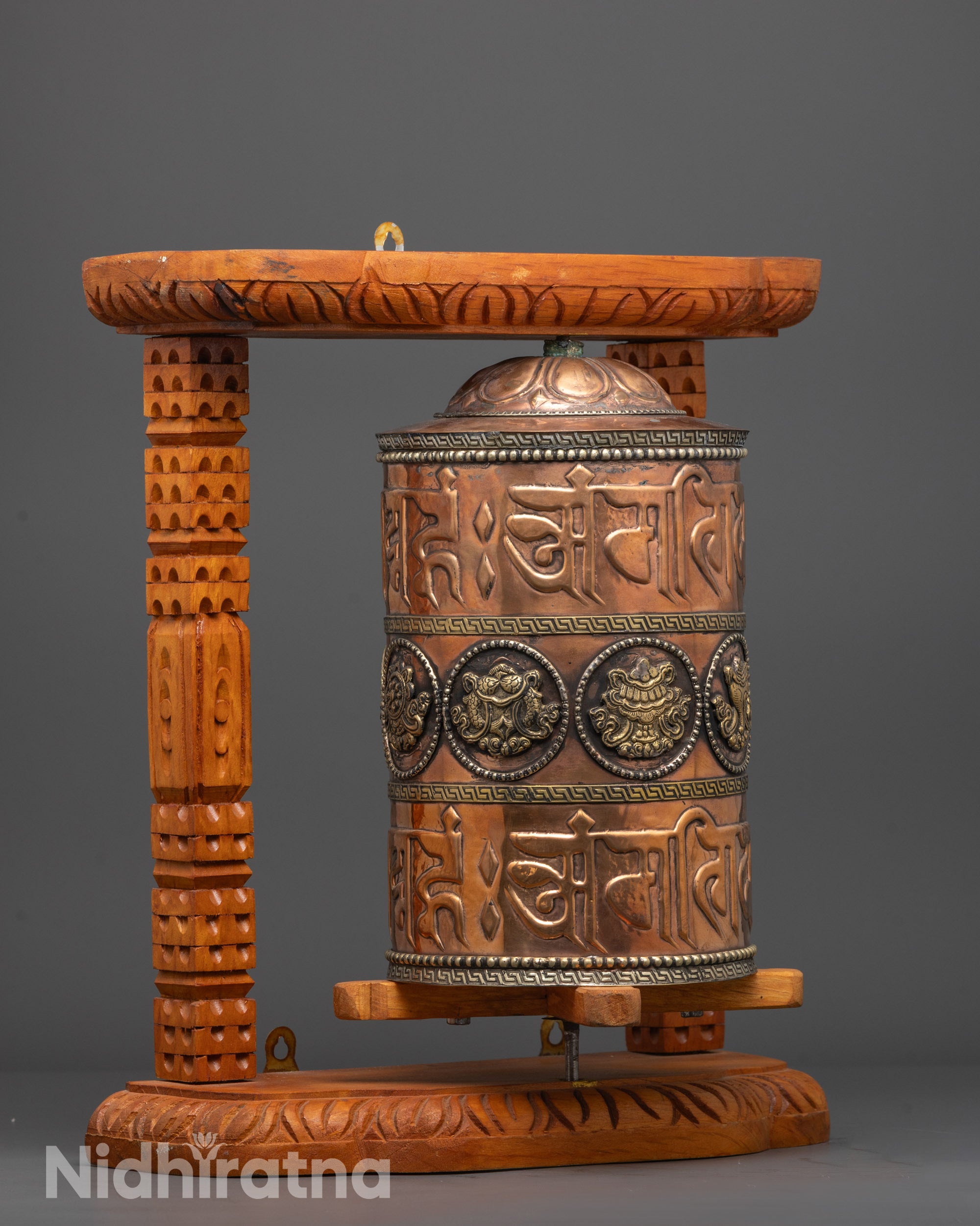 Tibetan Ashtamangala Prayer Wheel engraved with sacred mantras on copper base