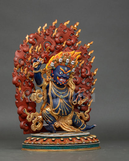 Tibetan Buddhist Chagna Dorje Vajrapani statue with gold robe and fierce protector gaze.
