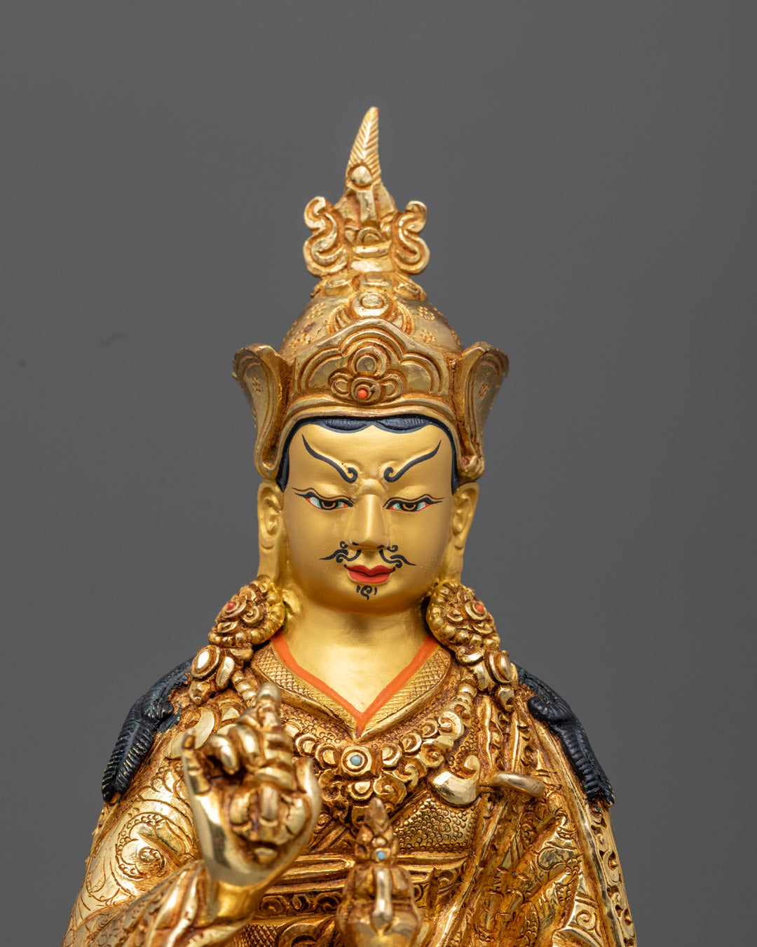 Tibetan Buddhist Tsokye Dorje deity statue with khatvanga, vajra, and vase of elixir, adorned with semi-precious stones and acrylic colors