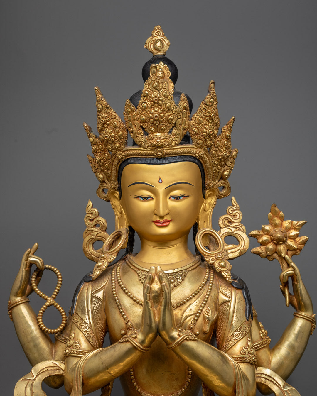Tibetan Chenrezig statue with acrylic colors, mala, utpala flower, and wish-fulfilling gem
