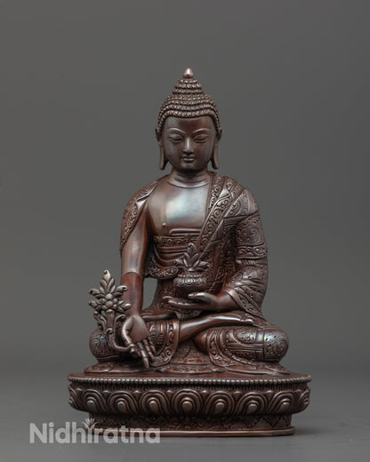 Tibetan Medicine Buddha sculpture front view showing monk’s bowl and myrobalan plant details