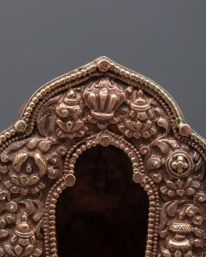Top-down close-up of hollow section inside gold Tibetan Ghau Box for sacred relics