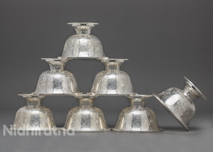 Top-down view of pure silver water offering bowl displaying its polished interior