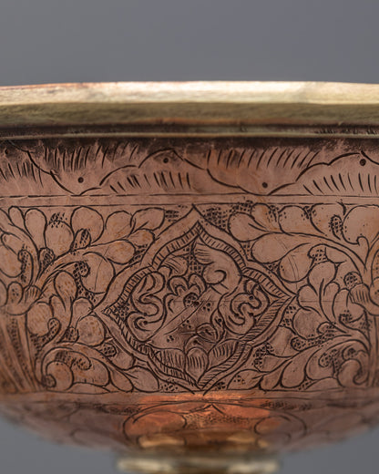 Top angle of traditional butter lamp showing artisan craftsmanship in copper
