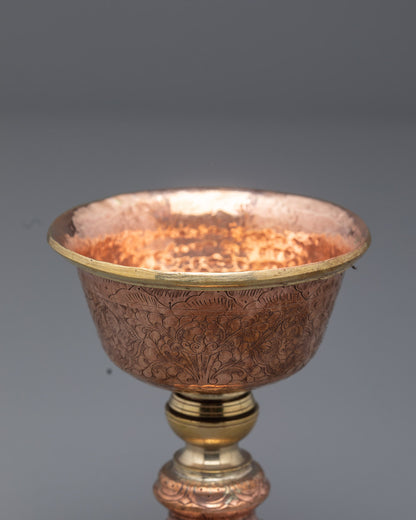 Top angle showing intricate hammered details on Nepalese copper butter lamp