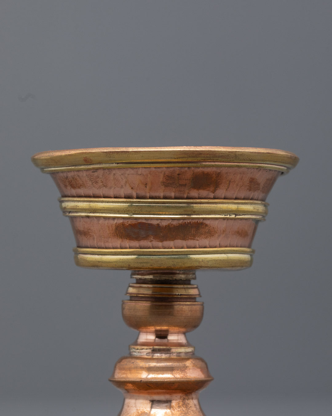 Top view of copper butter lamp used for Tibetan meditation rituals