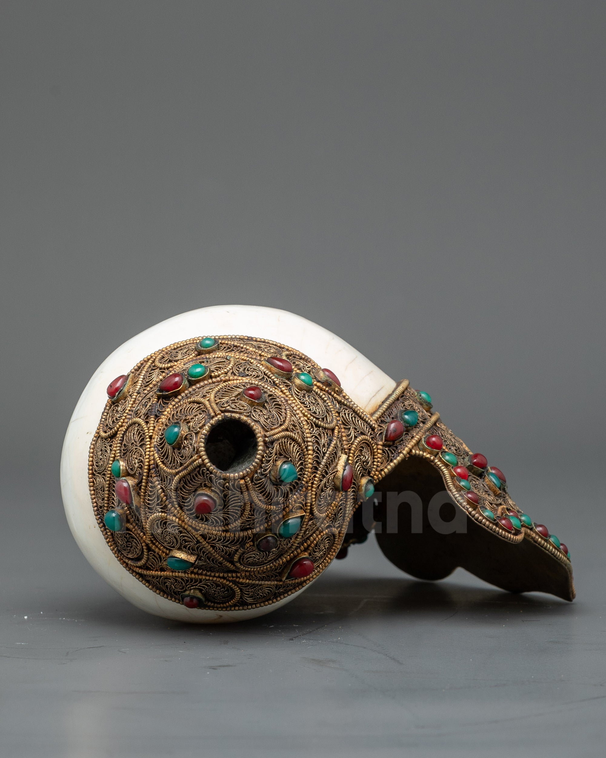 Top view ornate Tibetan conch shell with filigree work and gemstone embellishments