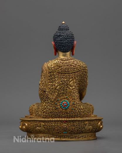 Traditional Nepalese artisan crafting a fire-gilded Shakyamuni Buddha statue using the ancient lost wax technique in a workshop.