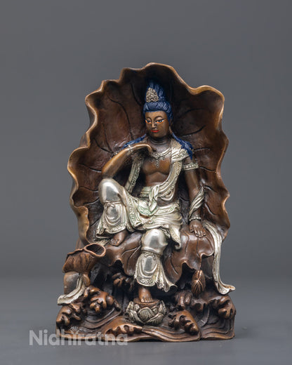 Traditional Nepali artisan painting acrylic colors on a Lokiteshvara statue using the lost wax method.