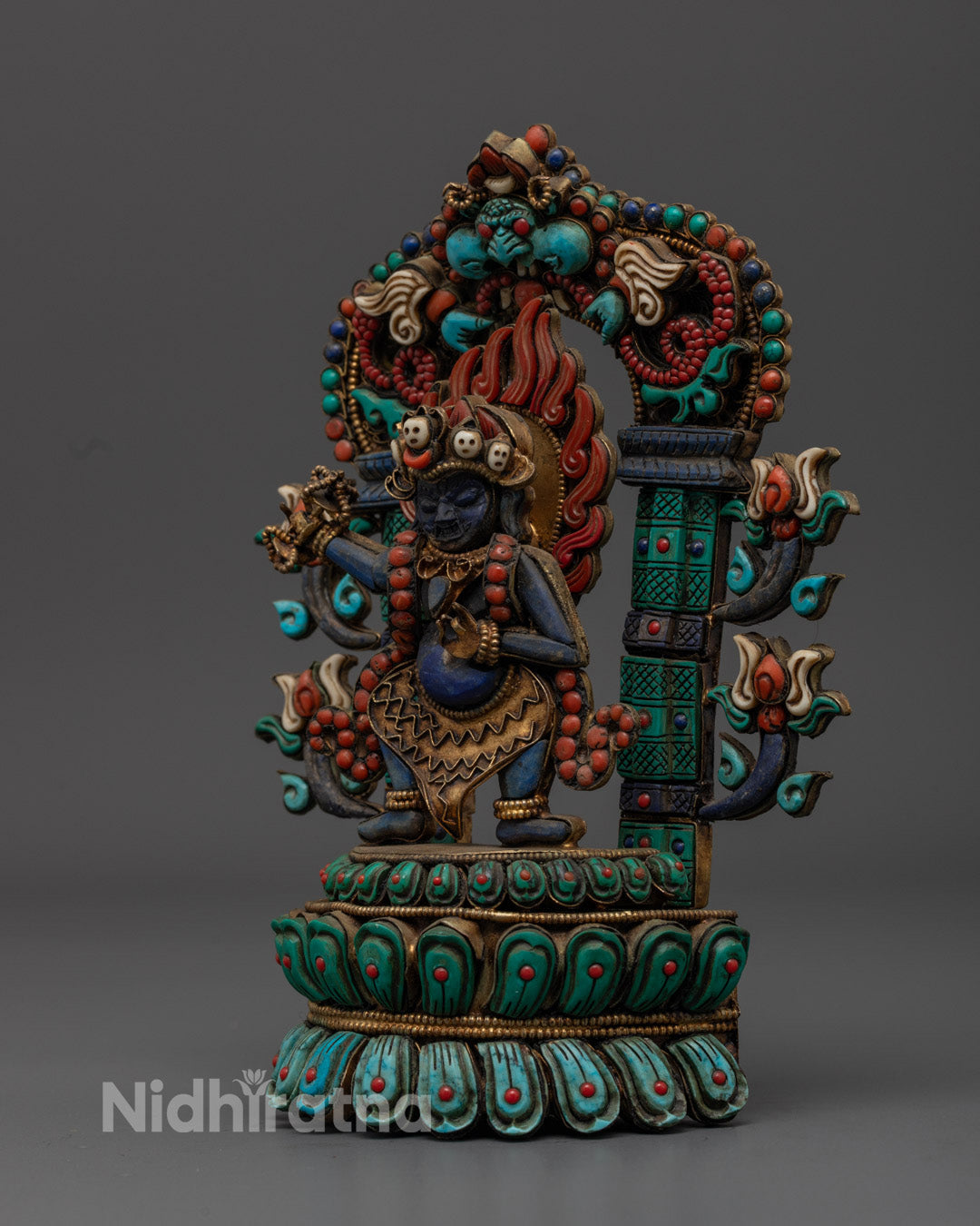 Traditional Vajrapani statue holding vajra and bell symbolizing power and compassion