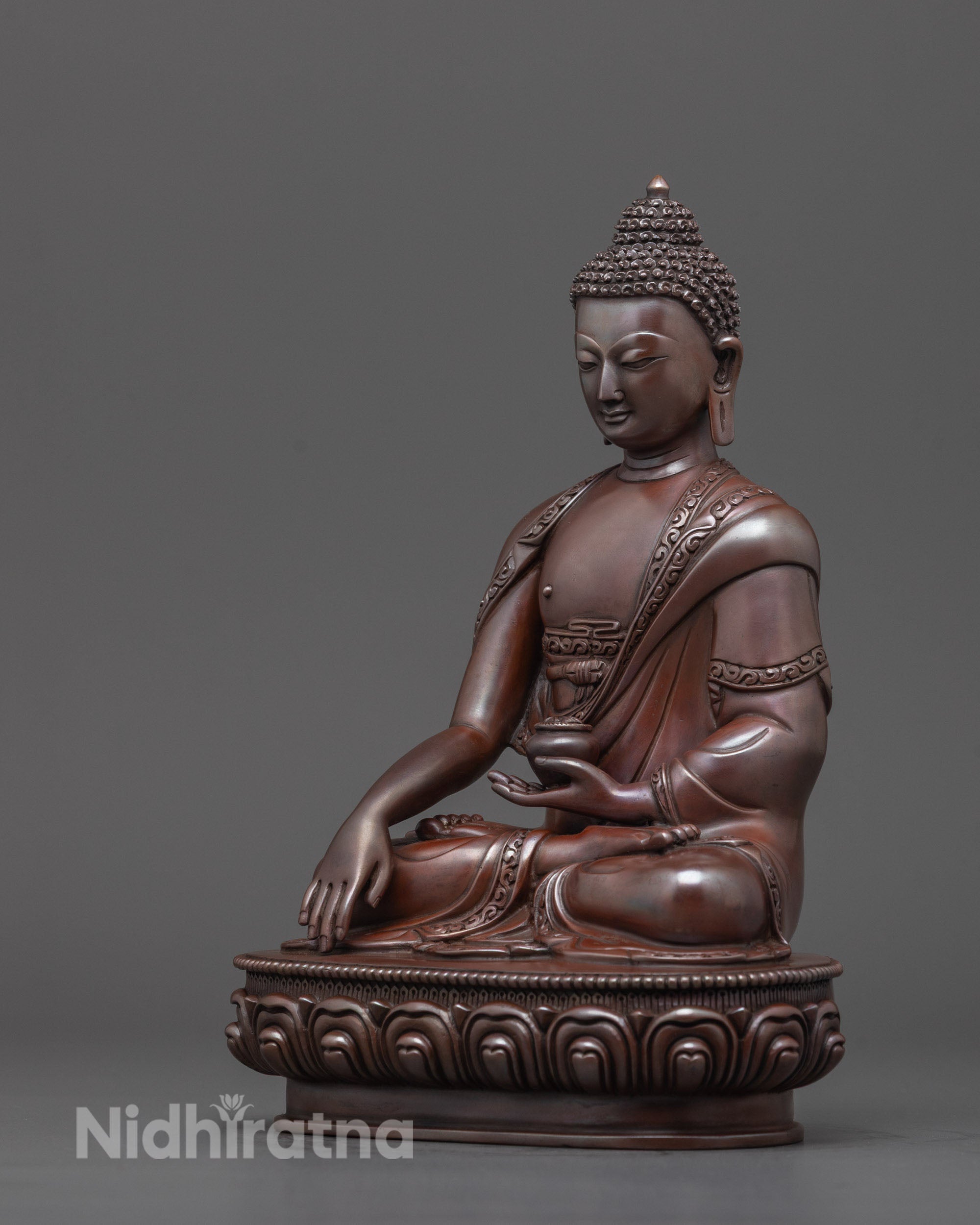 Traditional hand-carved Buddha figure from Nepal, oxidized copper,