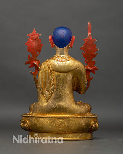 Back view of Tsongkhapa statue showing robe folds and detailed lotus pedestal carving