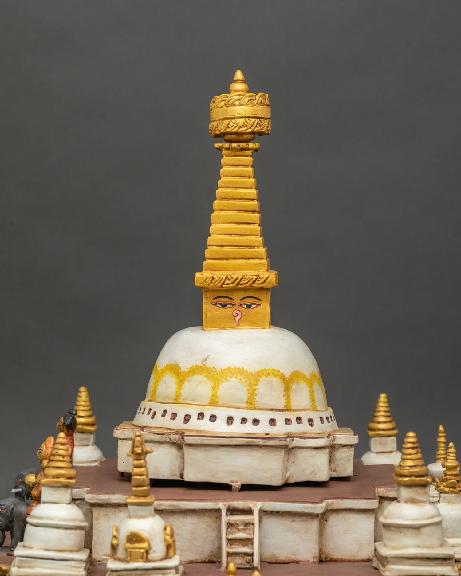 Upper spire detail of Boudhanath Stupa with golden tiered pinnacle