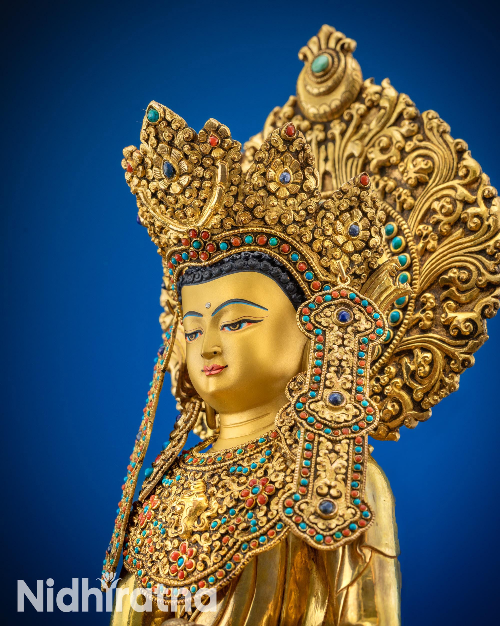 Upper close up of sacred Jowo Rinpoche Buddha statue gold-gilded face
