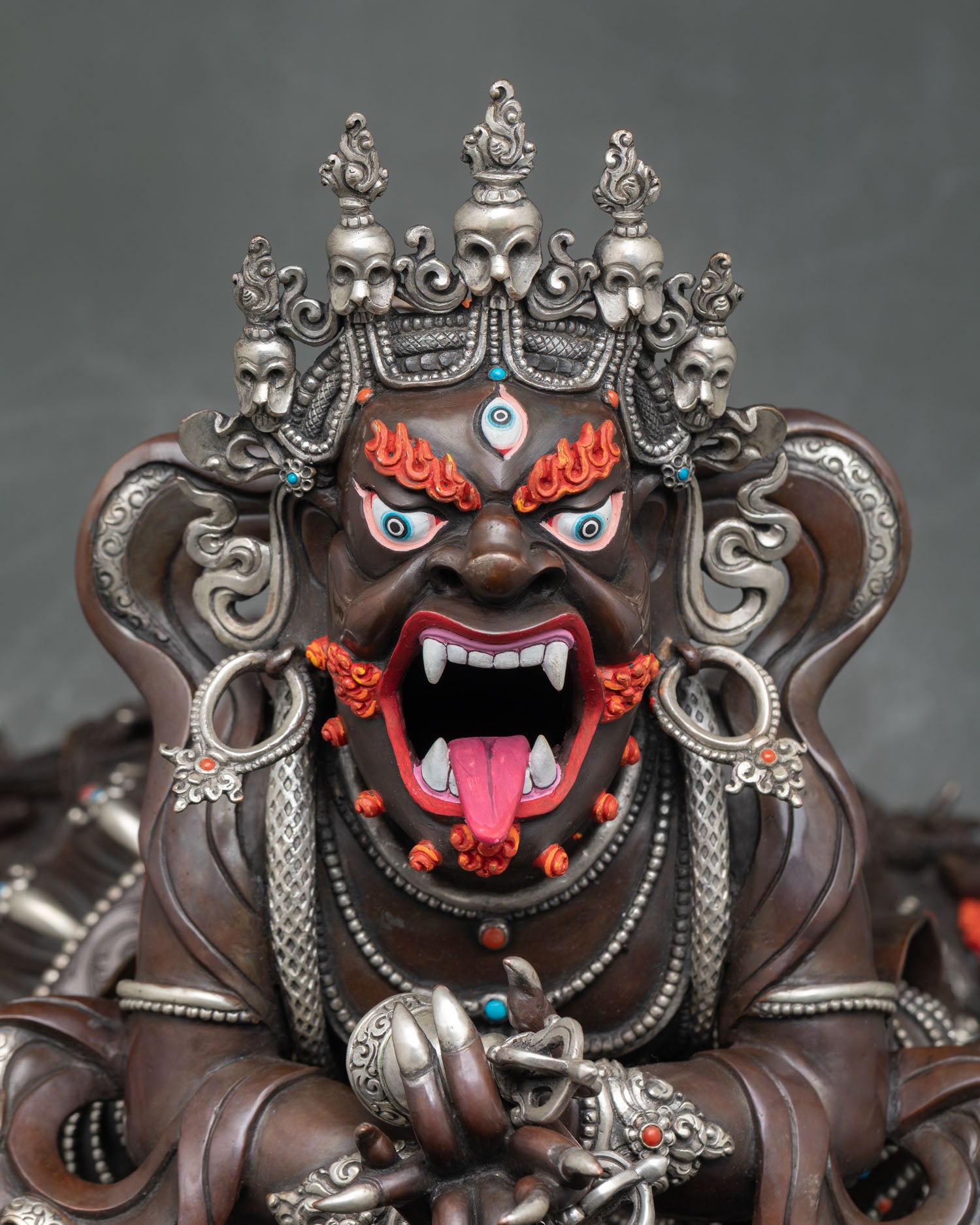 Vajradhaka statue close up view fierce face details open mouth fangs gold accents and sacred Himalayan craftsmanship