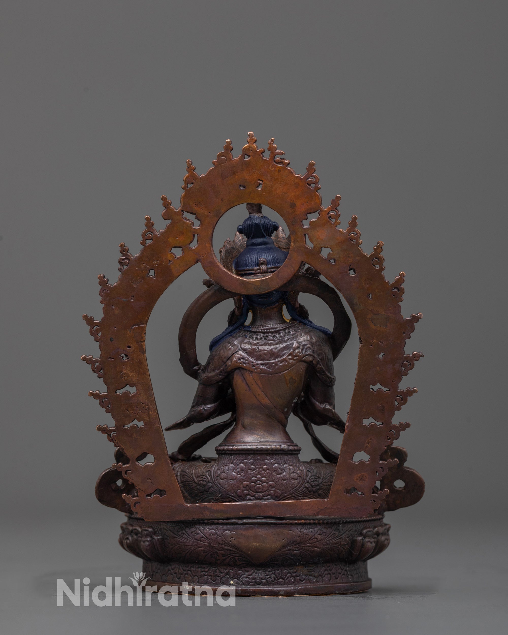 back view of precision-crafted Vajradhara statue showing halo and copper texture