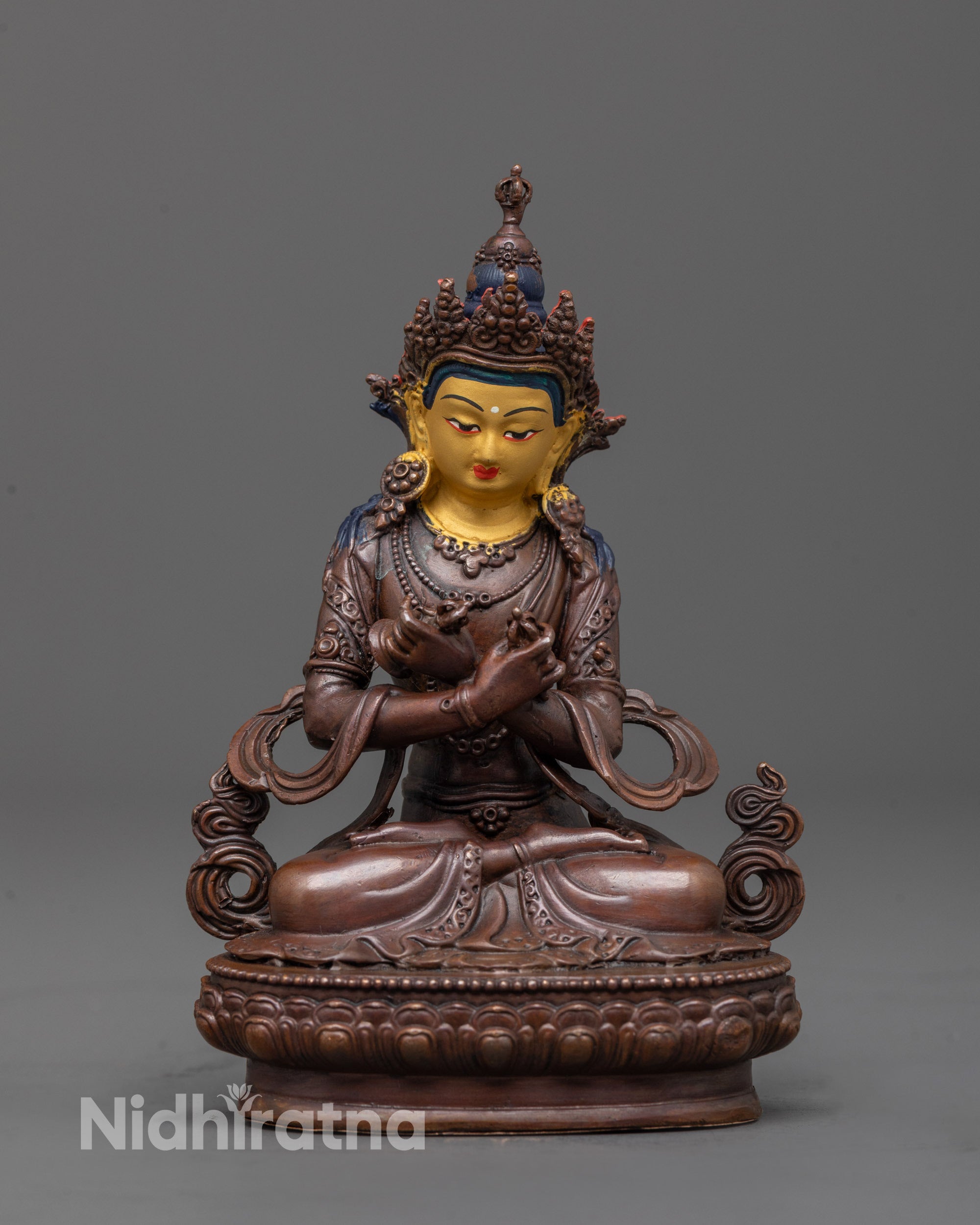 oxidized vajradhara statue front view with gold-plated face and lotus base