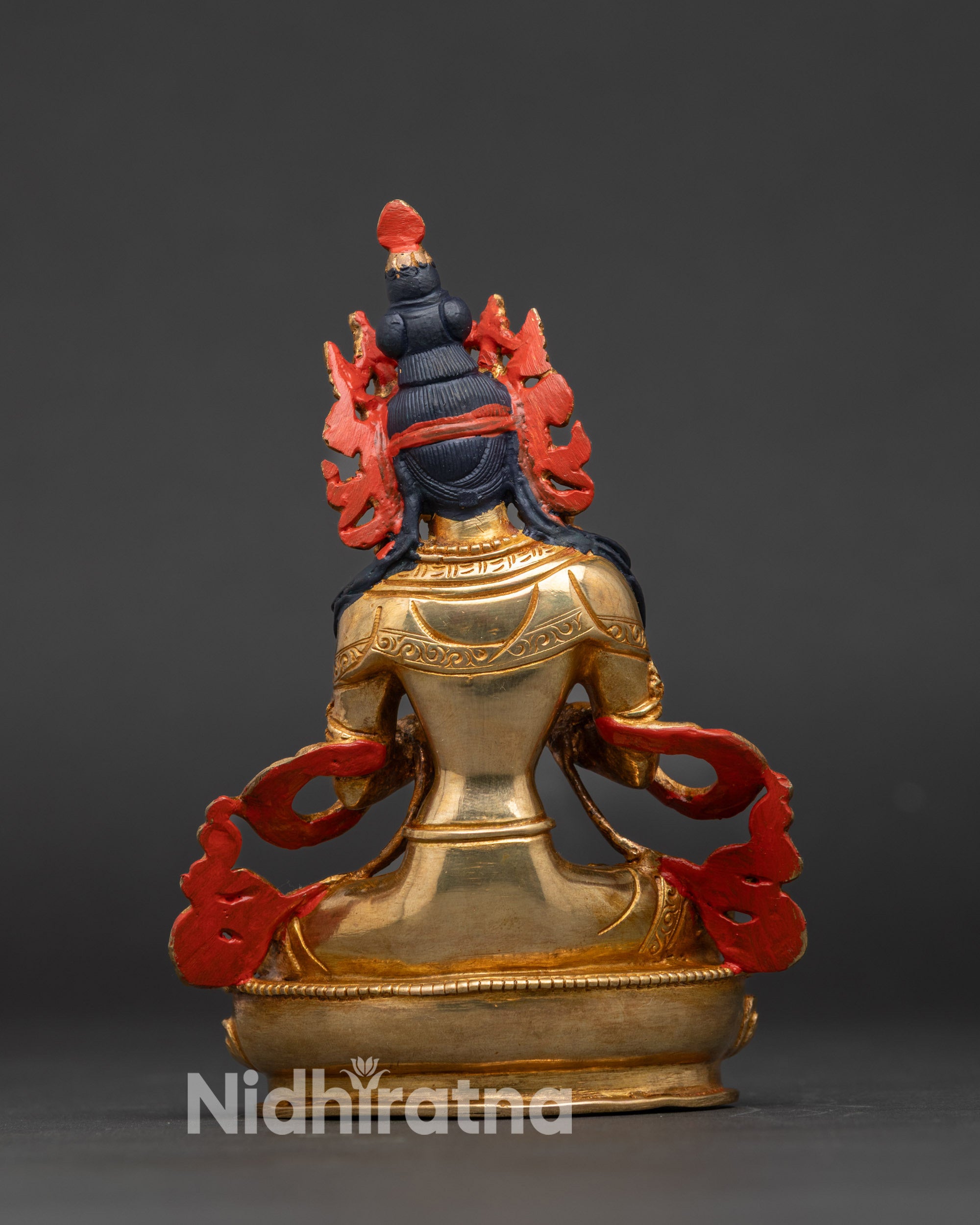 Vajradhara deity statue showing vajra and bell in crossed-arms gesture, sacred Buddhist art