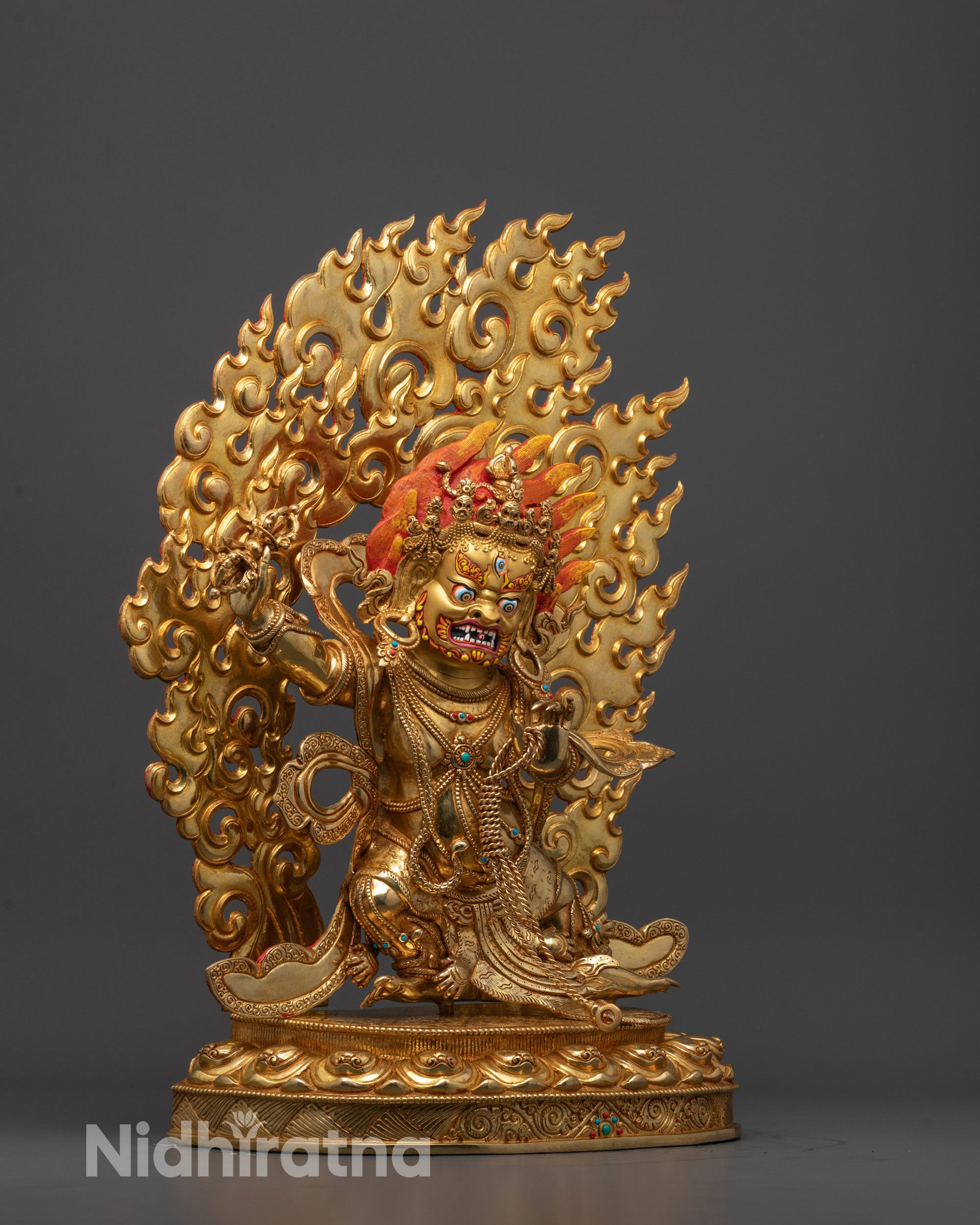 Side view of Vajrapani Statue with intricate carvings and gemstone-adorned halo
