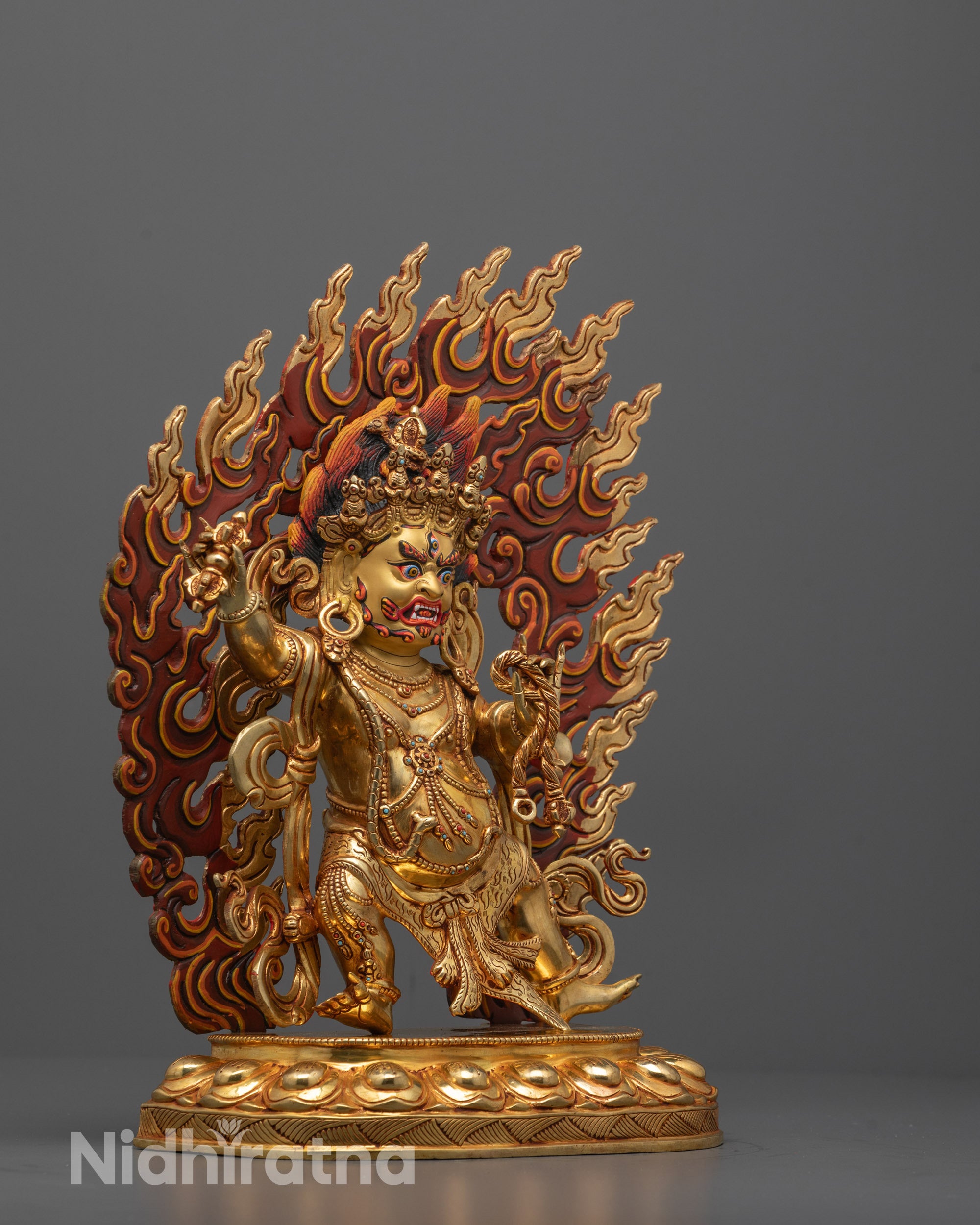 Side angle of Vajrapani Sculpture holding vajra and lasso in fierce stance