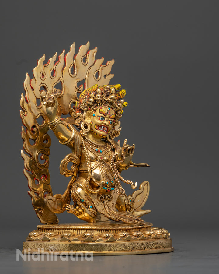 side view of gold plated vajrapani statue with copper base