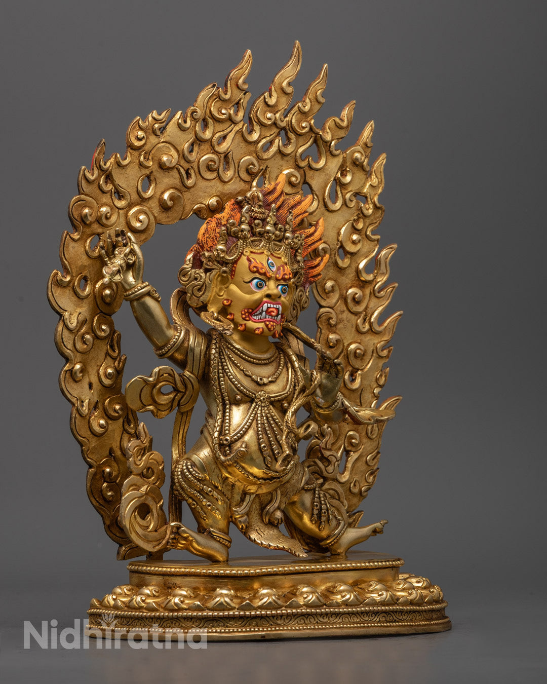 Vajrapani holding vajra and serpent-wrapped lasso necklace, symbolizing power to destroy ignorance and negative forces.