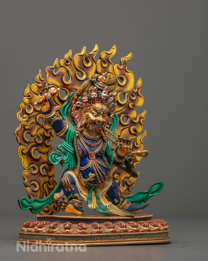 Vajrapani statue highlighting blazing flame halo, serpent garland, silk scarves, and vajra in hand, symbolizing spiritual power and protection