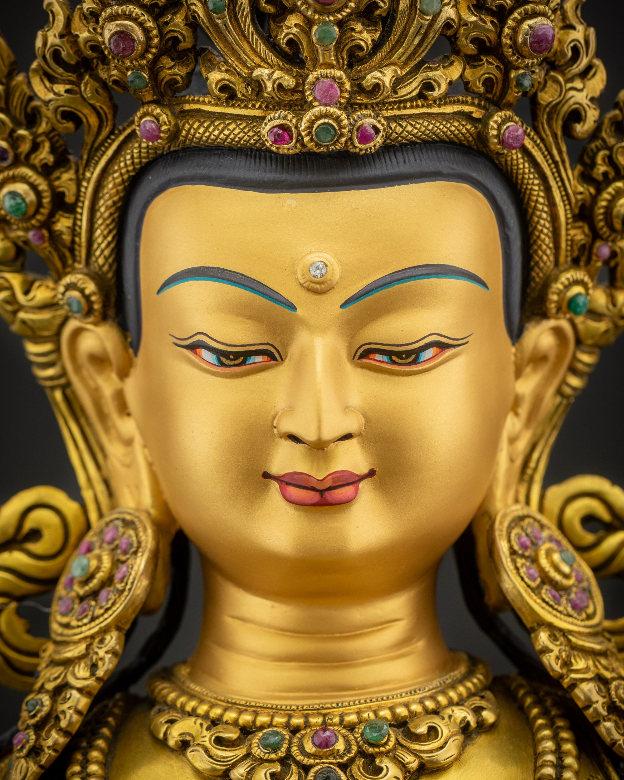Close-up of serene Vajrasattva face with 24K gold paint, calm expression, traditional Nepalese lost-wax casting