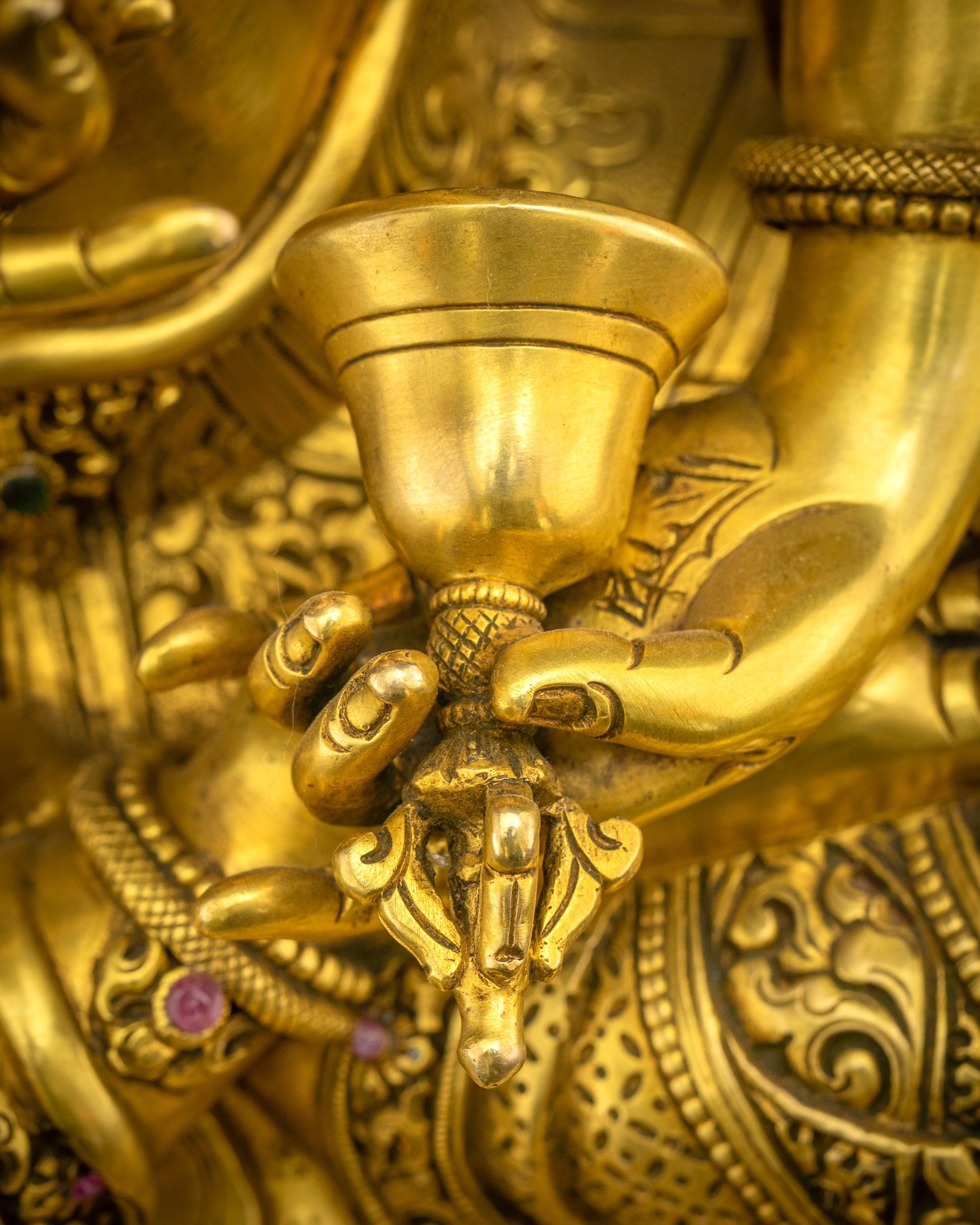 Close up of Vajrasattva Dorje Sempa statue holding ghanta (bell), symbolizing compassion in practice