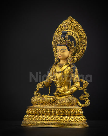 Left side view of Vajrasattva statue displaying five jewelled crown and floral halo carving