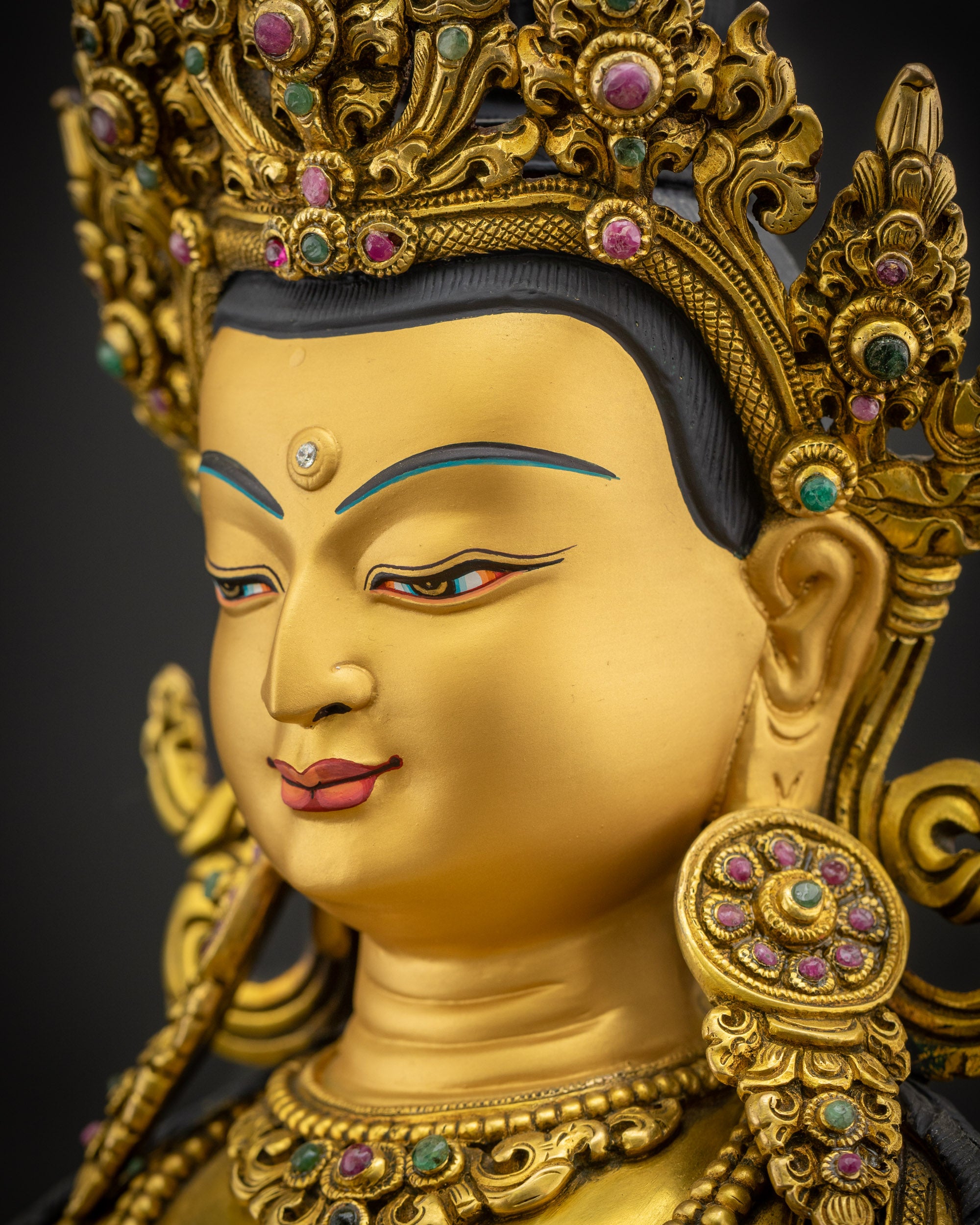 Side close up of Vajrasattva face showing refined features and traditional Nepalese metalwork