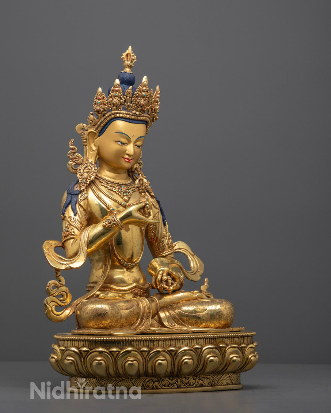 Vajrasattva statue handcrafted in Nepal, featuring radiant 24k gold gilding, seated on a lotus throne with a hollow chamber for auspicious mantras.