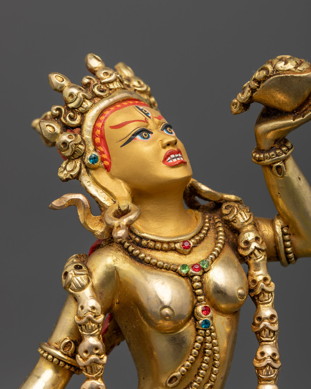 Vajrayogini Buddhist statue in copper with gold painted face and semi precious stone details.