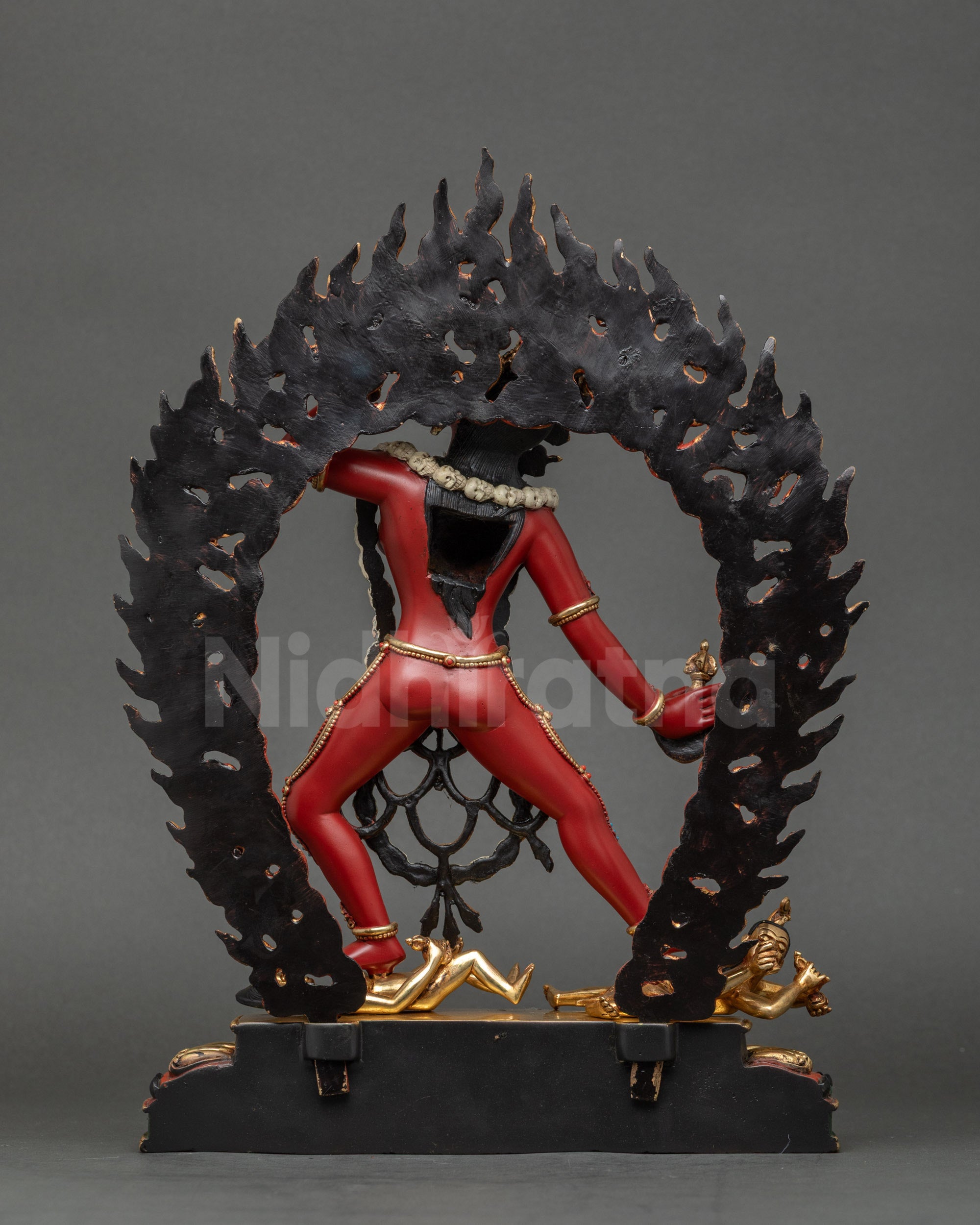 Vajrayogini Statue back view showing carved halo with flames and skull motifs