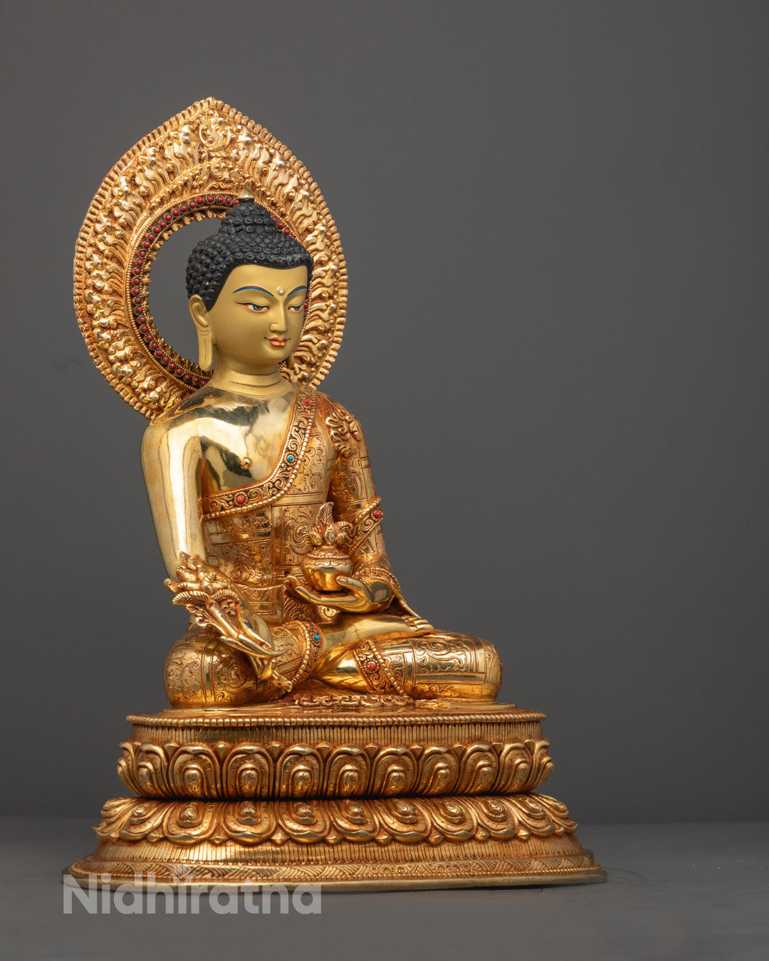 Vibrant acrylic-colored Medicine Buddha adorned with semi-precious stones, crafted in Nepal.