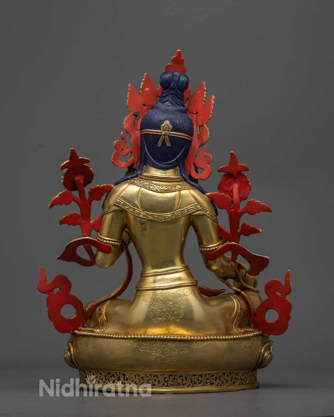 Vibrantly colored Green Tara Statue painted with acrylics, highlighting the detailed craftsmanship and semi-precious stone adornments.