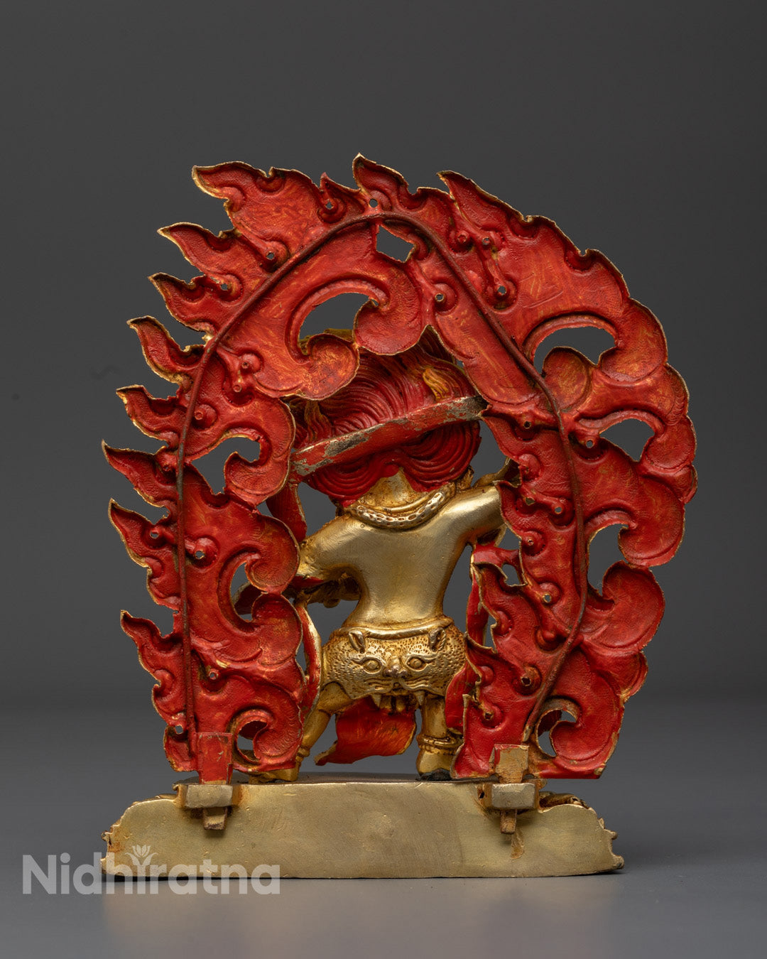 Vibrantly colored Vajrapani statue with fierce expression, showcasing traditional Nepalese fire-gilding technique
