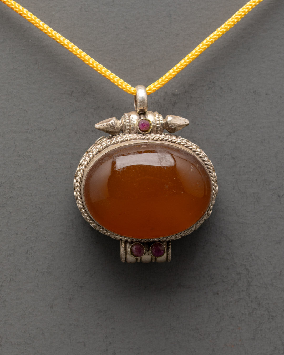 Vintage Tibetan Carnelian Locket front view with vibrant stone and coral inlays, handcrafted detail
