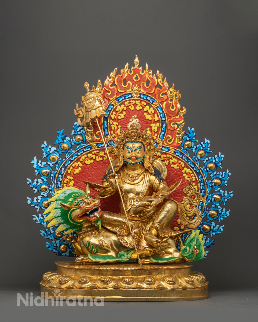 Wealth Deity Namtoshe statue’s 24K gold-gilded face with fierce expression, third eye, and five-jeweled crown in Tibetan Buddhist art.