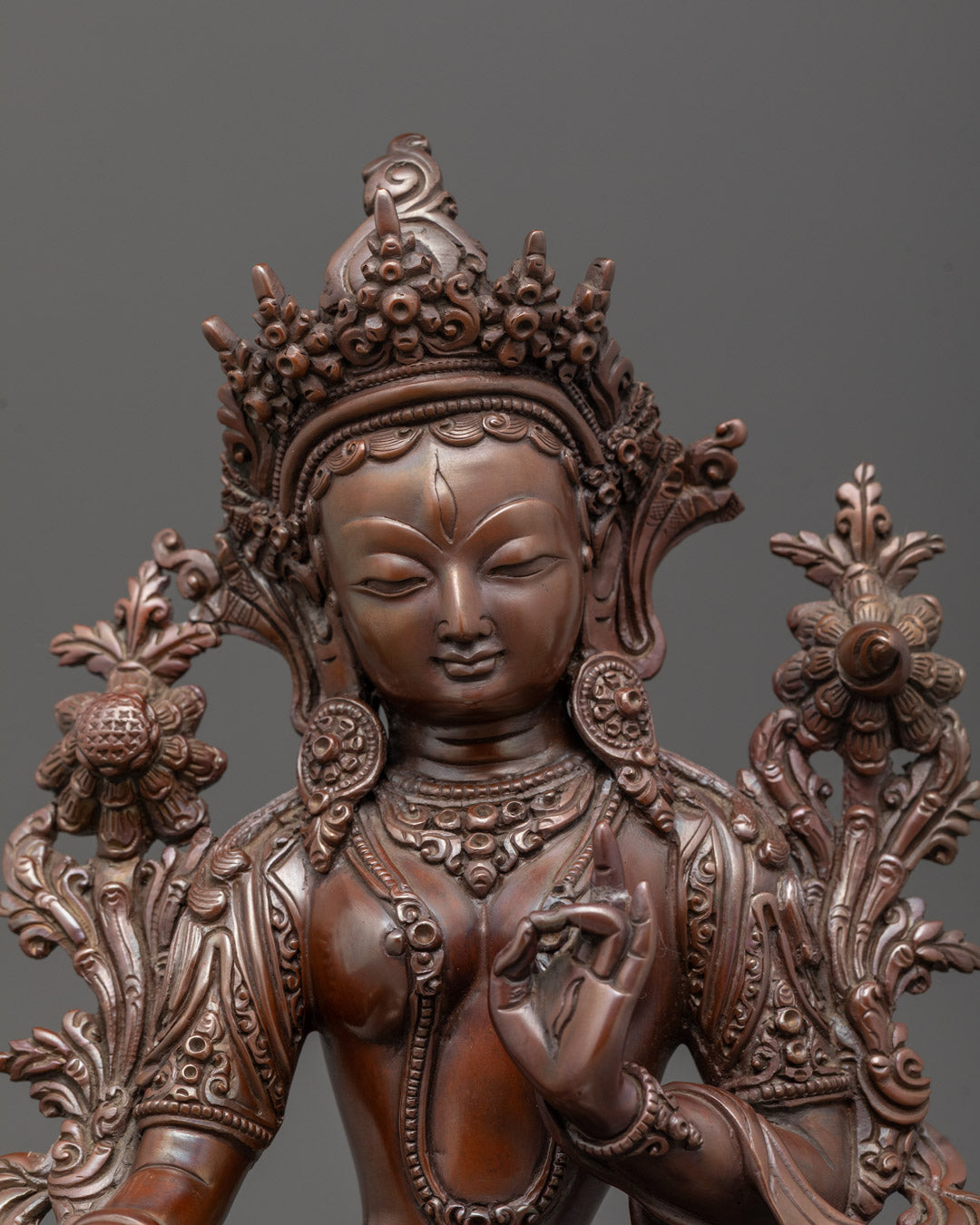 Close-up of White Tara Buddha face oxidized copper Patan artisan lost wax Tibetan statue