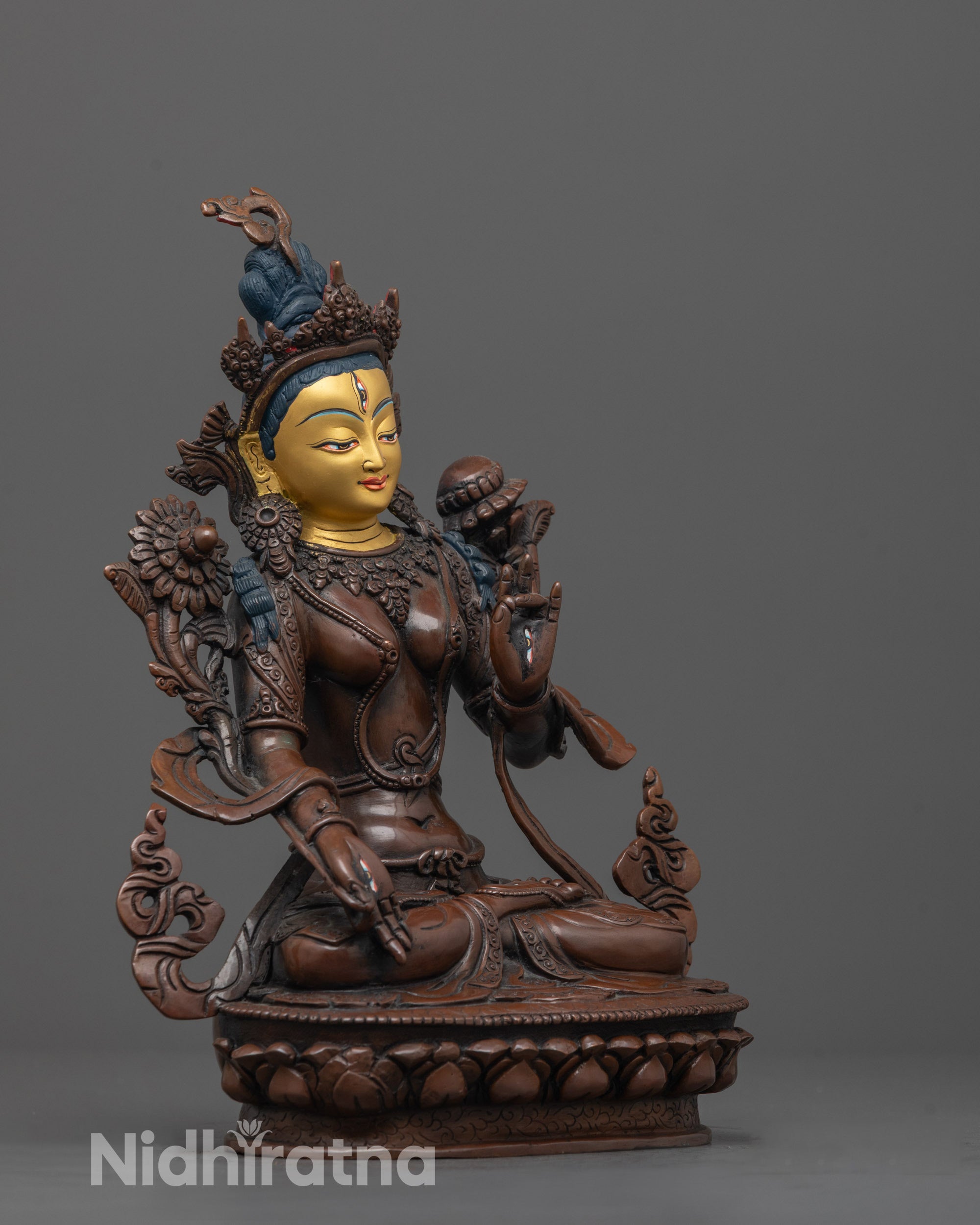 Side view of White Tara Statue showing utpala flower and graceful seated posture
