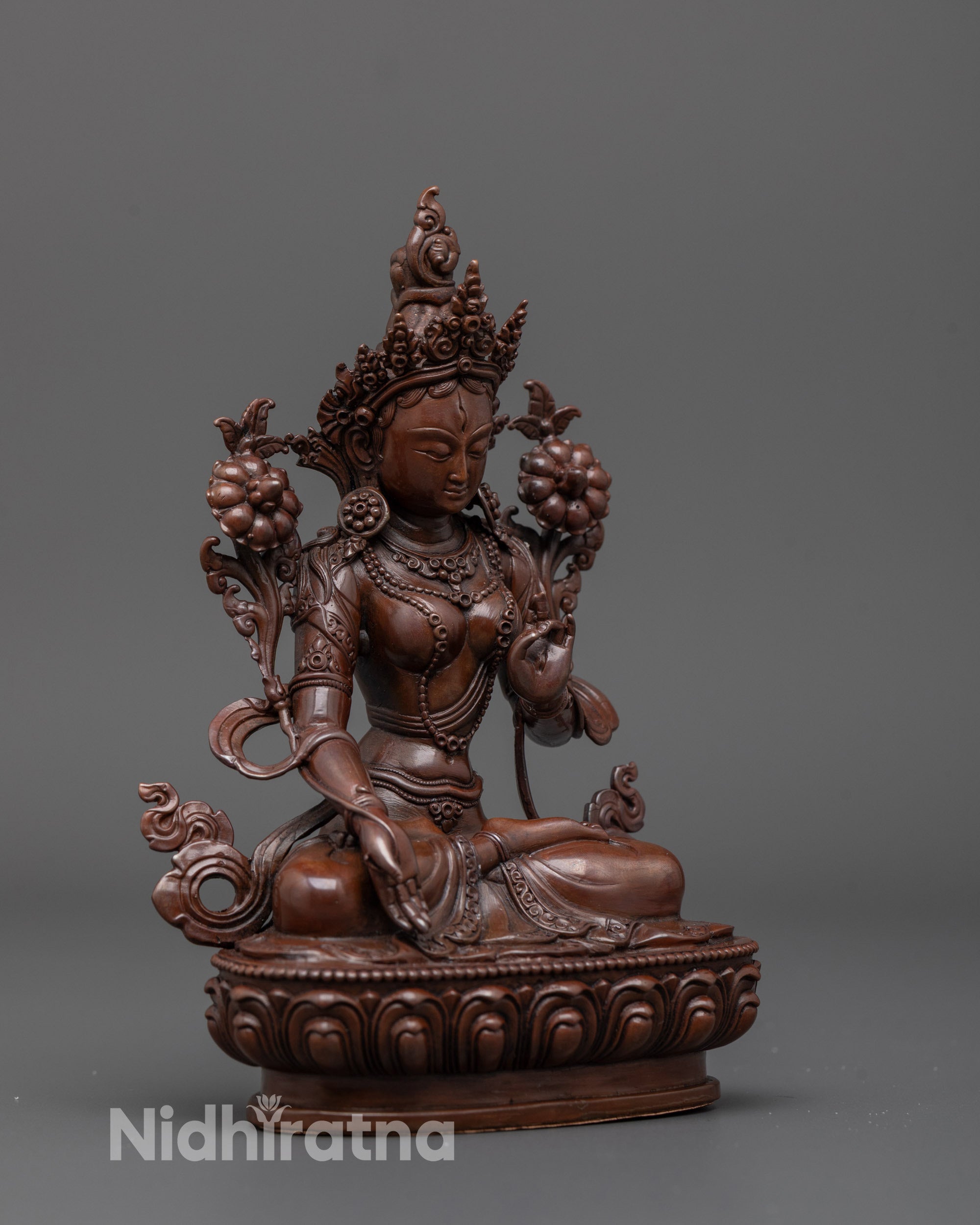 Side angle of machine-made White Tara statue showing hollow lotus seat for mantra focus