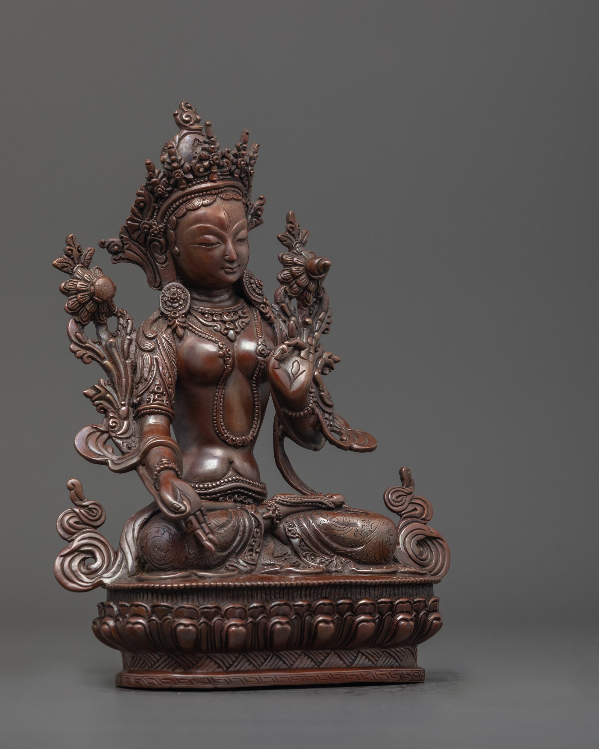 Side angle of beautifully hand-carved White Tara Statue in oxidized copper