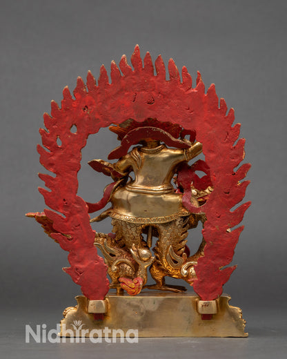 White Dzambhala statue holding trident, jewel, scepter, and mongoose, symbolizing wealth