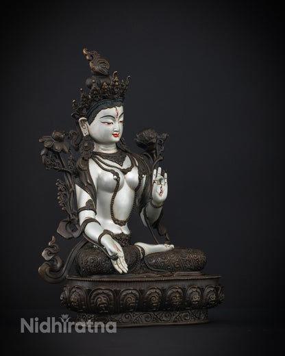 White Tara statue made from oxidized copper, highlighting elegant hand-carved details and meditative posture.