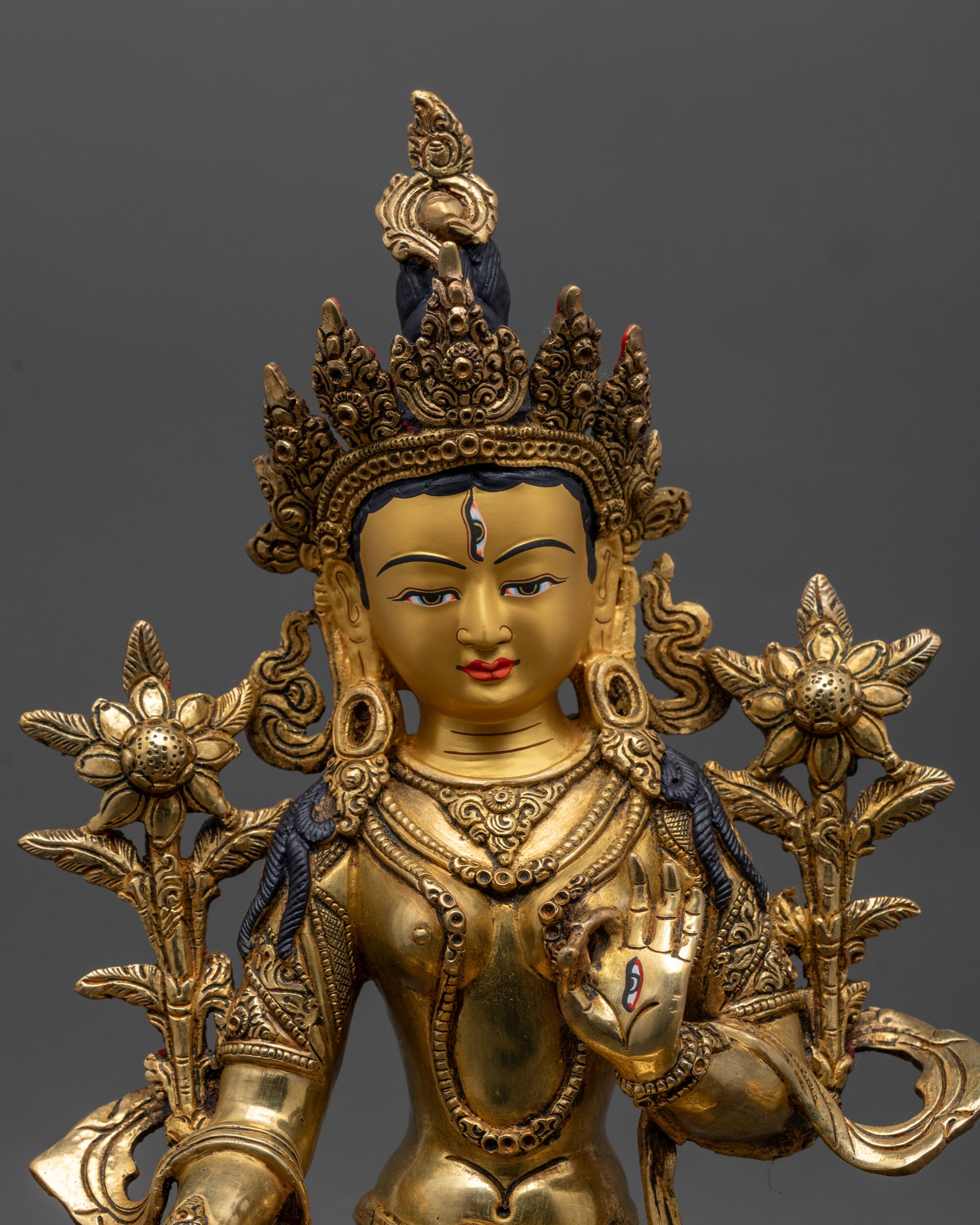 White Tara Statue close up of hand-carved patterns on robes and lotus seat
